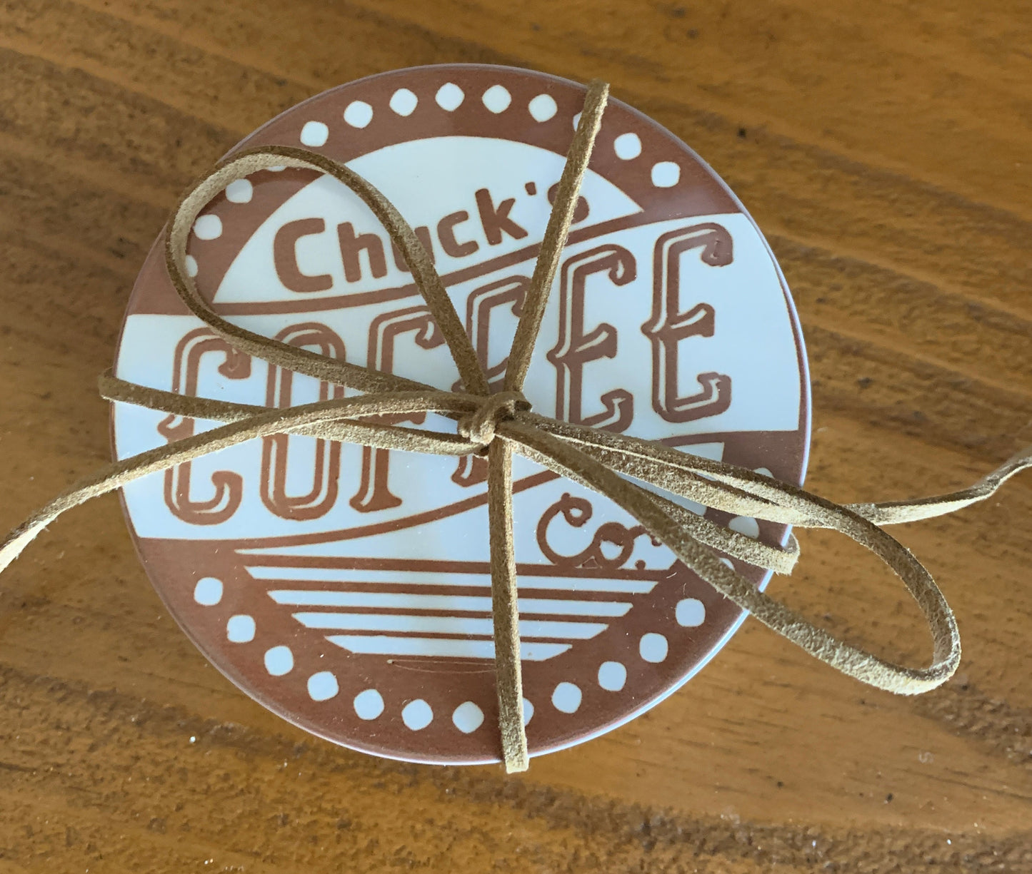 Sets of coasters come wrapped with leather string.