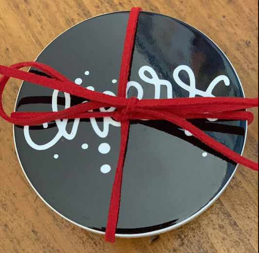 Sets of coasters come wrapped with leather string